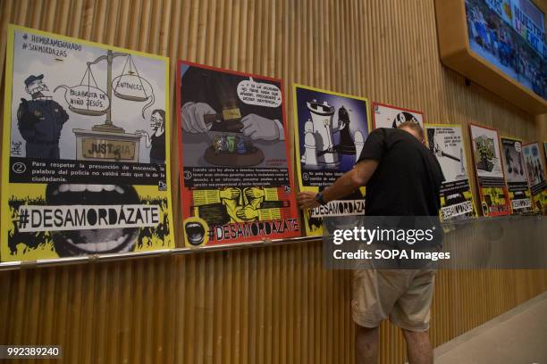 Activist seen placing one of the posters against the famous Law. The Congress hosted a parliamentary session on the possible reform of the Gag Law...