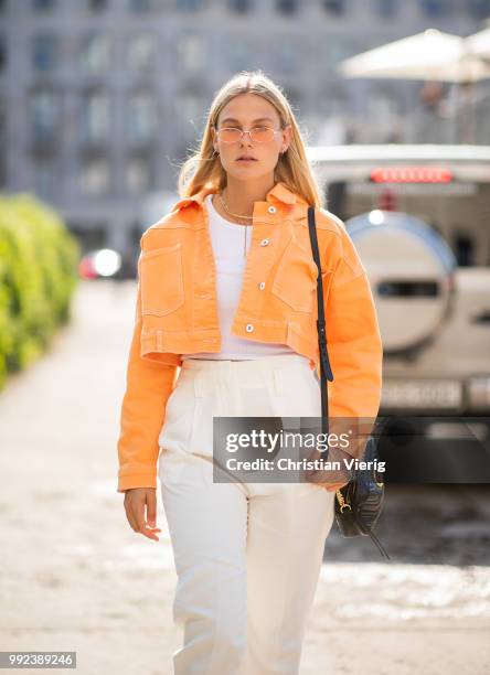 Alessa Winter wearing orange cropped denim jacket is seen outside Lana Mueller during the Berlin Fashion Week July 2018 on July 5, 2018 in Berlin,...