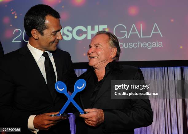 The actor Erol Sander and his laudator Fritz Wepper celebrate the award "Genießer des Jahres 2018" during the 20th Busche Gala at the "Rocco Forte",...