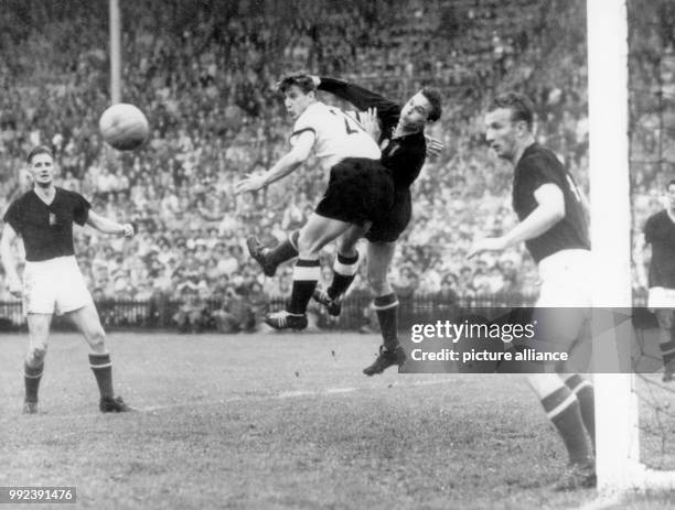 The German forward Hans Schaefer and the Hungarian goalkeeper Gyula Grosics miss the corner throw which the forward Helmut Rahn turns into a score in...