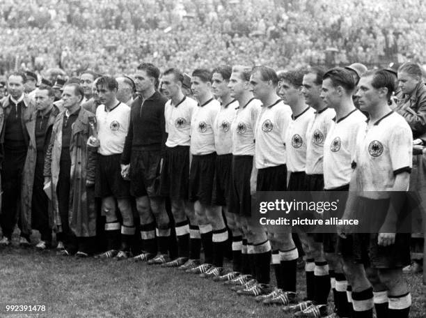 The German national team stands before 53000 spectators after their 3-2 victory against Hungary at the World Cup at the Wankdorf Stadium in Bern,...