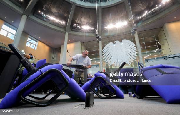 Dpatop - Men work on the allocation of seats in the plenary hall of the German Parliament in Berlin, Germany, 17 October 2017. The seating had to...