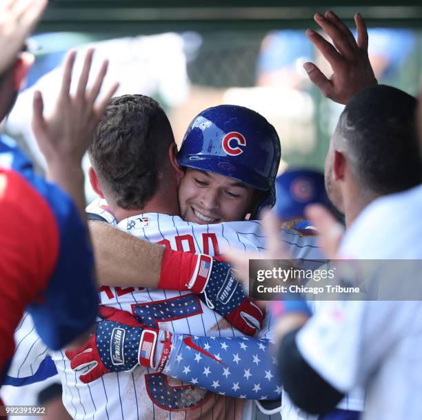 The Chicago Cubs' David Bote is hugged by teammate Albert Almora Jr. After hitting his first major league home run, in the second inning against the...