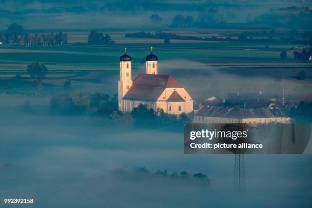 Fog shrouds the monastery Oberalteich, Germany, 17 October 2017. Photo: Armin Weigel/dpa