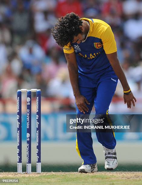 Sri Lankan cricketer Lasith Malinga reacts after a catch was dropped of his bowling during the ICC World Twenty20 first semifinal match between Sri...