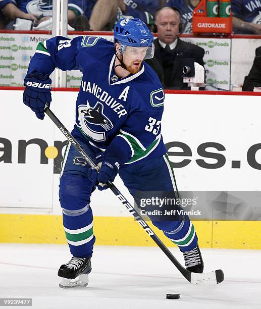 Henrik Sedin of the Vancouver Canucks skates up ice with the puck in Game 6 of the Western Conference Semifinals against the Chicago Blackhawks...