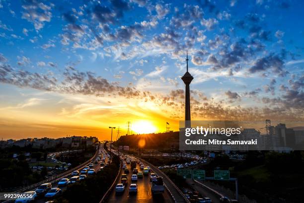 milad tower and street at sunset, tehran, iran - tehran street stock pictures, royalty-free photos & images