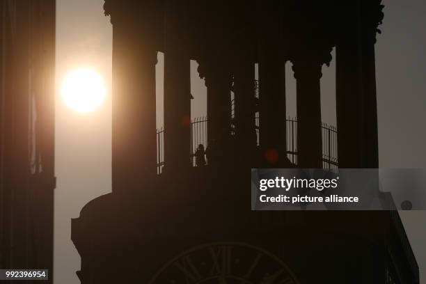 The tower of the St. Michaelis Church can be seen against the sunlight in Hamburg, Germany, 17 October 2017. The sun has appeared in a reddish orange...