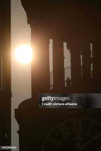 The tower of the St. Michaelis Church can be seen against the sunlight in Hamburg, Germany, 17 October 2017. The sun has appeared in a reddish orange...