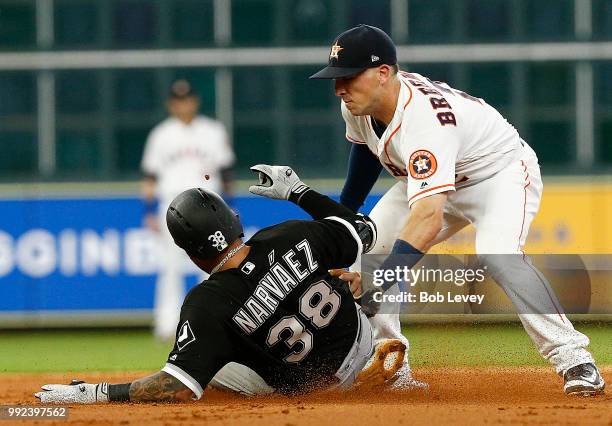 Omar Narvaez of the Chicago White Sox is tagged out by Alex Bregman of the Houston Astros attempting to stretch a single in the third inning at...