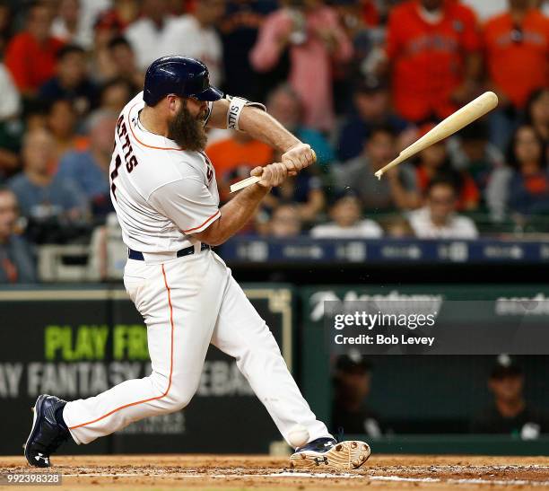 Evan Gattis of the Houston Astros breaks his bat on a check swing in the third inning against the Chicago White Sox at Minute Maid Park on July 5,...