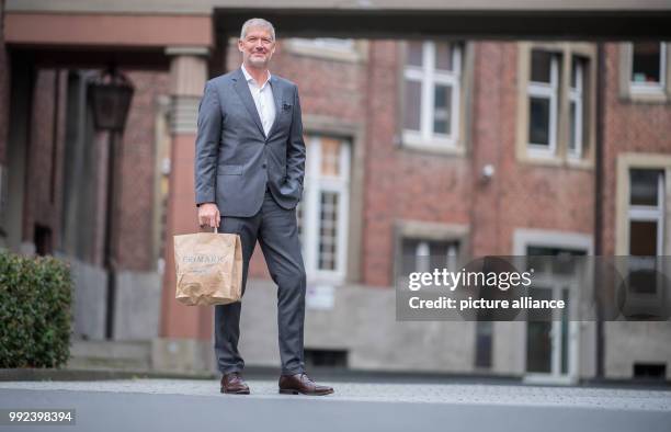 Wolfgang Krogmann, the head of the German arm of the clothes discounter Primark, holds a Primark bag in Münster, Germany, 17 October 2017. The chain...