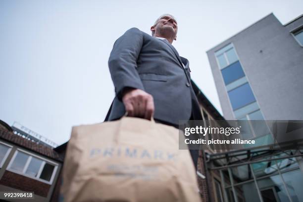 Wolfgang Krogmann, the head of the German arm of the clothes discounter Primark, holds a Primark bag in Münster, Germany, 17 October 2017. The chain...