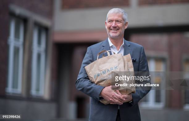 Wolfgang Krogmann, the head of the German arm of the clothes discounter Primark, holds a Primark bag in Münster, Germany, 17 October 2017. The chain...