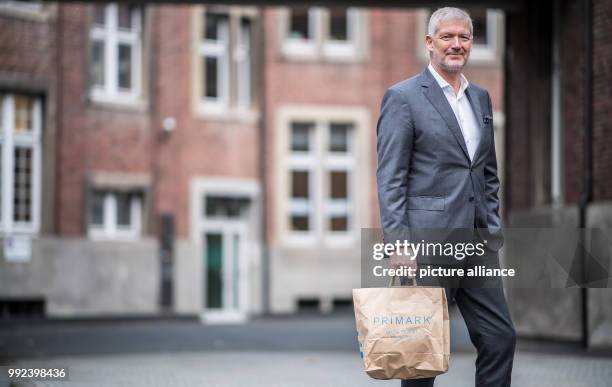 Wolfgang Krogmann, the head of the German arm of the clothes discounter Primark, holds a Primark bag in Münster, Germany, 17 October 2017. The chain...