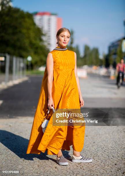 Lisa Banholzer wearing mustard dress seen outside Dawid Tomaszewski during the Berlin Fashion Week July 2018 on July 5, 2018 in Berlin, Germany.