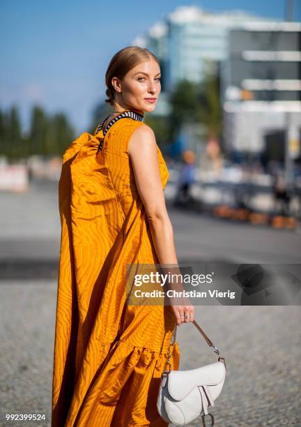 Lisa Banholzer wearing mustard dress seen outside Dawid Tomaszewski during the Berlin Fashion Week July 2018 on July 5, 2018 in Berlin, Germany.