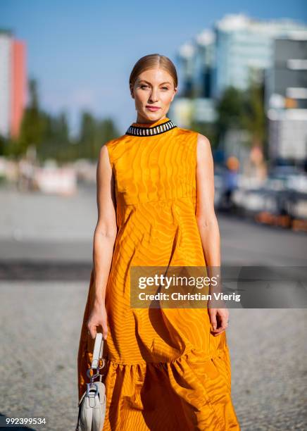 Lisa Banholzer wearing mustard dress seen outside Dawid Tomaszewski during the Berlin Fashion Week July 2018 on July 5, 2018 in Berlin, Germany.