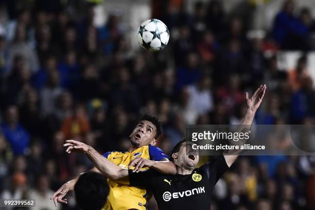Dortmund's Sokratis Papastathopoulos and Nicosia's Igor De Camargo vie for the ball during the Champions League group stages qualification match...