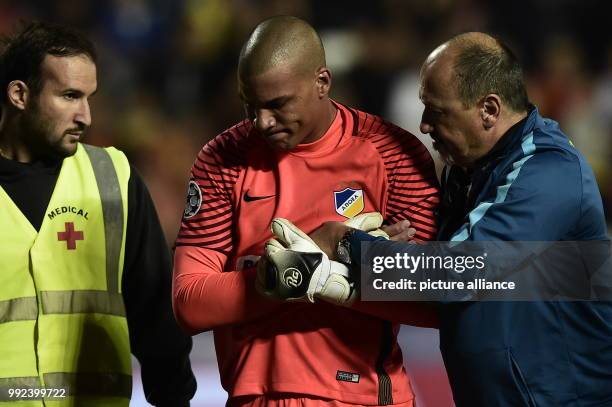 Nicosia's keeper Boy Waterman leaves the field after suffering an injury during the Champions League group stages qualification match between...