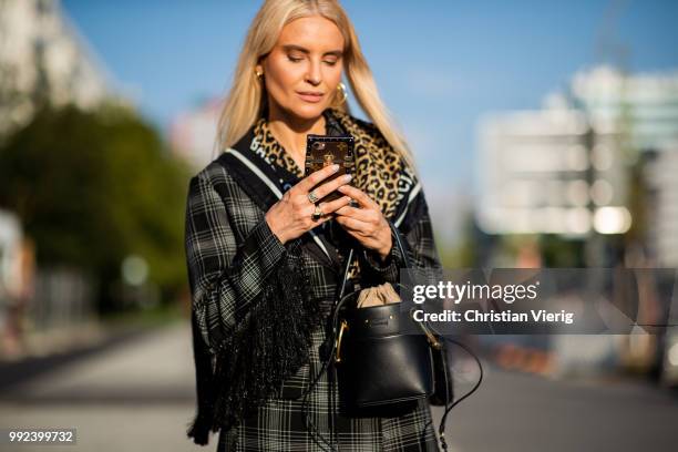 Joanna Horodynska wearing biker pants, plaid jacket, bucket bag, Balenciaga scarf is seen outside Dawid Tomaszewski during the Berlin Fashion Week...