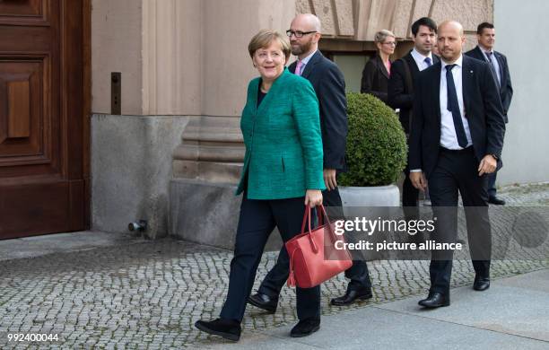 German Chancellor Angela Merkel and general secretary from the Christian Democratic Union of Germany Peter Traube arrive for the Exploratory...