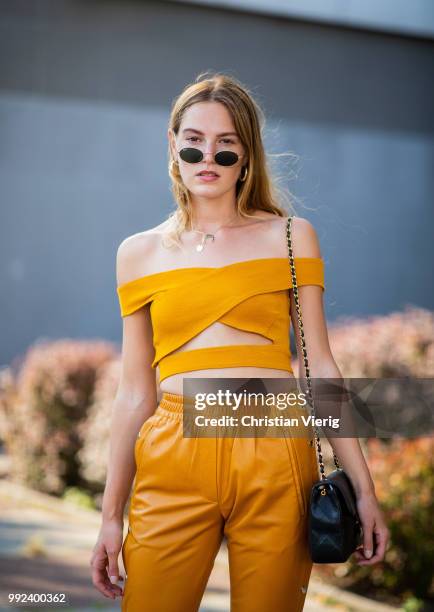 Hannah Pot d'Or wearing mustard cropped top and pants seen outside Dawid Tomaszewski during the Berlin Fashion Week July 2018 on July 5, 2018 in...