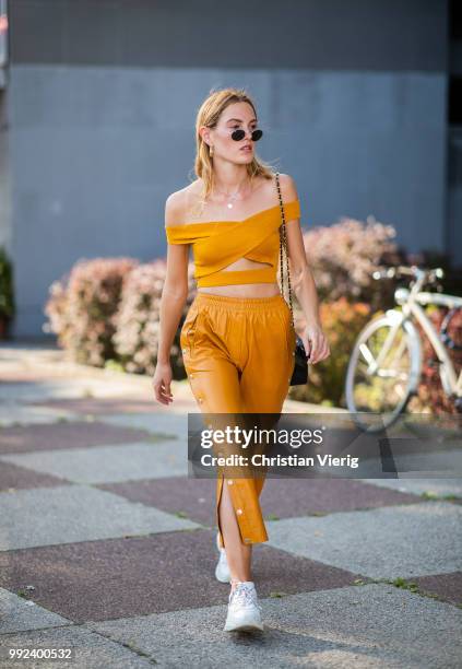 Hannah Pot d'Or wearing mustard cropped top and pants seen outside Dawid Tomaszewski during the Berlin Fashion Week July 2018 on July 5, 2018 in...