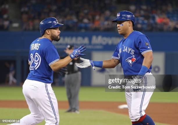 Yangervis Solarte of the Toronto Blue Jays is replaced by pinch-runner Devon Travis after drawing a walk in the ninth inning during MLB game action...