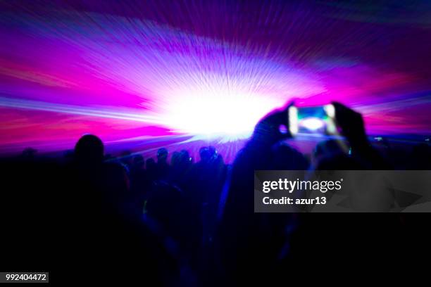 laser show party rays in front of smartphone filming video - laser show stock pictures, royalty-free photos & images