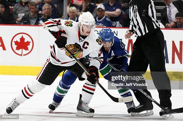 Ryan Kesler of the Vancouver Canucks and Jonathan Toews of the Chicago Blackhawks battle after a face-off in Game 6 of the Western Conference...