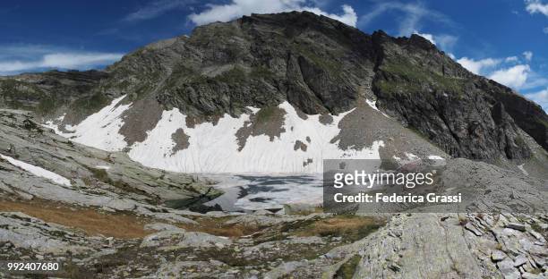 panoramic of alpine lake and mountain pass in bognanco valley - lepontinische alpen stock-fotos und bilder