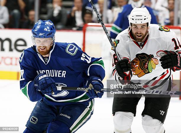 Daniel Sedin of the Vancouver Canucks and Andrew Ladd of the Chicago Blackhawks skate up ice in Game 6 of the Western Conference Semifinals during...