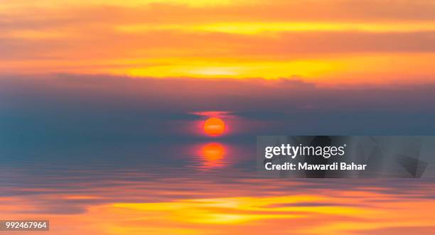 sunset with slow shutter and bot silhouette - slow shutter stock pictures, royalty-free photos & images