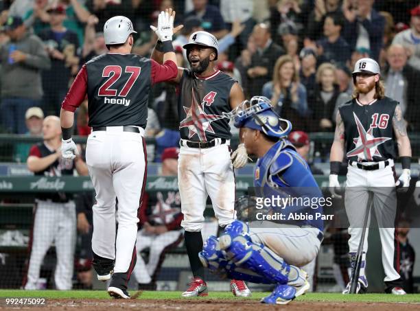 Ryon Healy high fives Denard Span of the Seattle Mariners after hitting a two run home run in the second inning against the Kansas City Royals during...