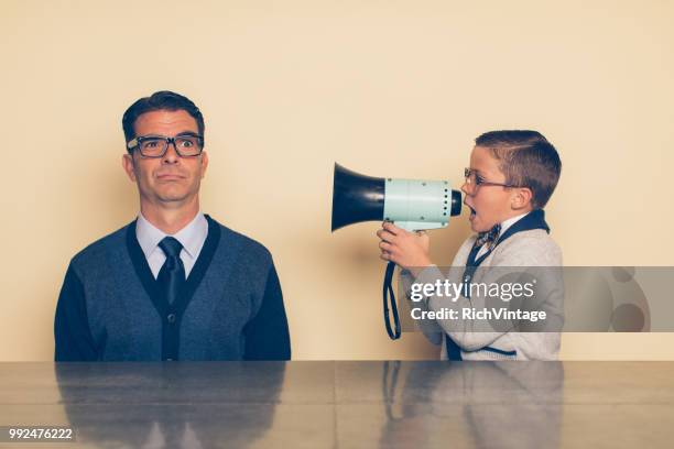 young nerd boy yelling at dad through megaphone - crazy dad stock pictures, royalty-free photos & images