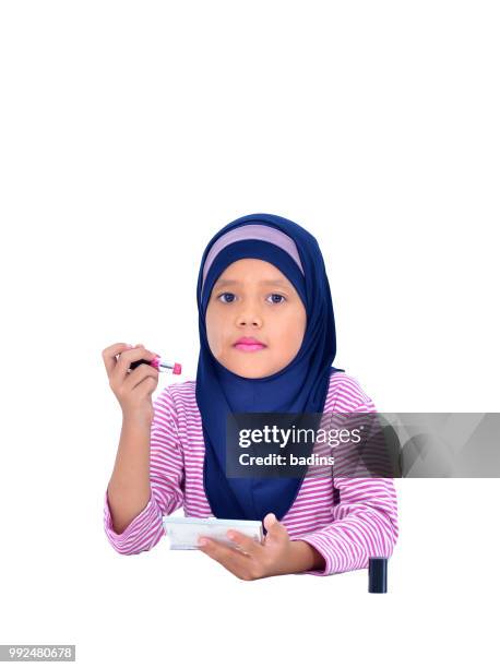 portrait of a beautiful muslim kid applying lipstick isolated on white background - white lipstick 個照片及圖片檔