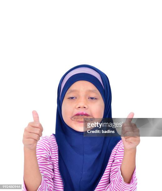 portrait of a beautiful muslim kid eat cookies isolated on white background - malaysia beautiful girl 個照片及圖片檔