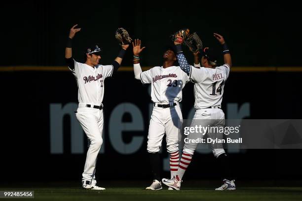 Christian Yelich, Keon Broxton, and Hernan Perez of the Milwaukee Brewers celebrate after beating the Minnesota Twins 2-0 at Miller Park on July 3,...