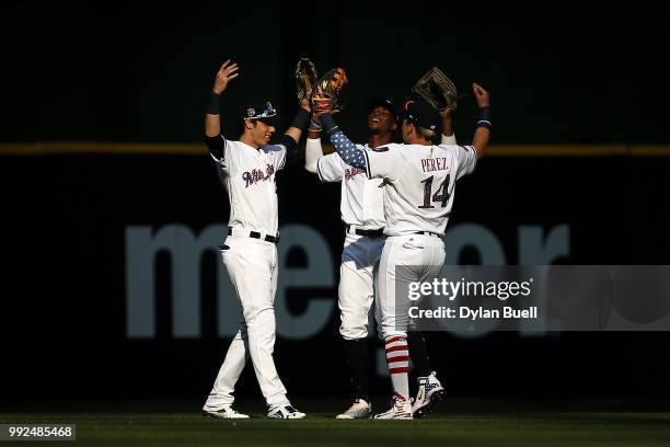 Christian Yelich, Keon Broxton, and Hernan Perez of the Milwaukee Brewers celebrate after beating the Minnesota Twins 2-0 at Miller Park on July 3,...