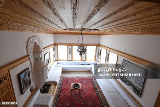 The guest reception room at the house of Albanian writer Ismail Kadare at the UNESCO protected city of Gjirokastra on June 14, 2018. - The Lolomani...