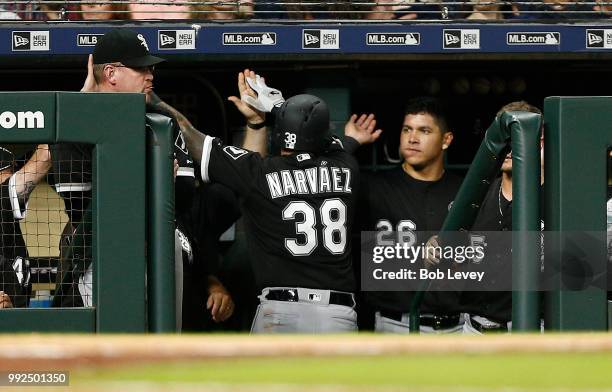 Omar Narvaez of the Chicago White Sox receives high fives after hitting a home run in the sixth inning against the Houston Astros at Minute Maid Park...