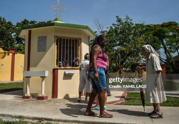 Nun approaches a new little chapel built with donations from Cubans living abroad at Saint Lazarus National Sanctuary in El Rincon, Havana, on July...