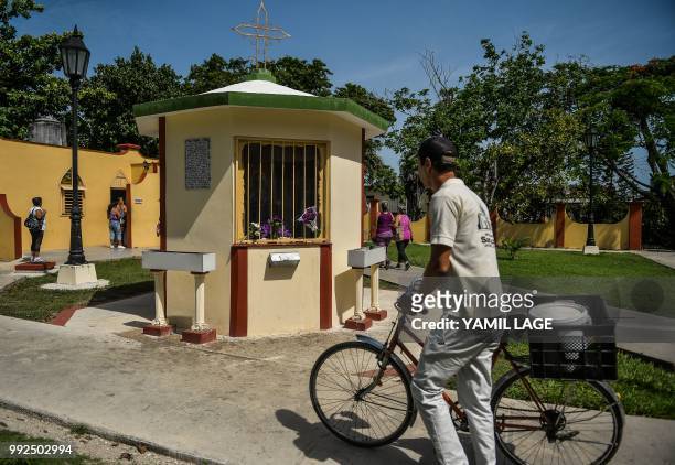 Man walks past a new little chapel built with donations from Cubans living abroad at Saint Lazarus National Sanctuary in El Rincon, Havana, on July...