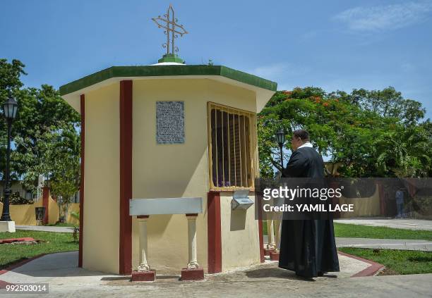 Priest Elixander Torres prays at a new little Chapel built with donations from Cubans living abroad at Saint Lazarus National Sanctuary in El Rincon,...