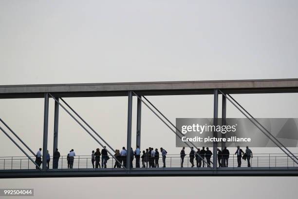 Dpatop - People stand on the bridge connecting the two buildings of the German parliament as coalition talks to form the next government begin in...