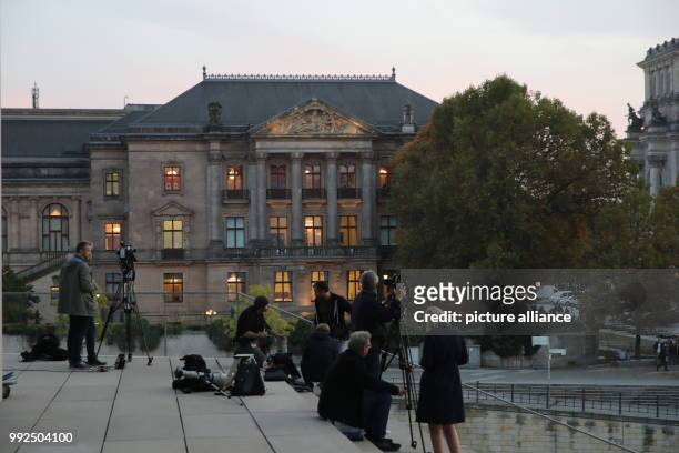 Journalists gather in front of the Parliamentary Society House as coalition talks to form the next government begin in Berlin, Germany, 18 Octobr...