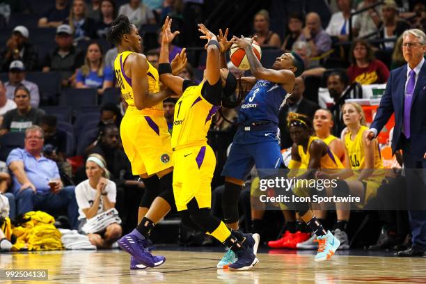 Los Angeles Sparks guard Odyssey Sims , center, is fouled by Minnesota Lynx guard Danielle Robinson during the regular season game between the Los...