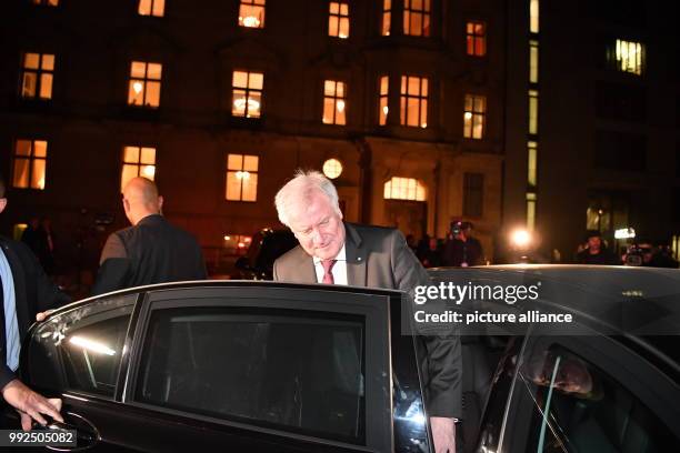 Leader Horst Seehofer climbs into a car after taking part in the first round of coalition talks to form the next government begin in Berlin, Germany,...