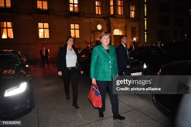 German chancellor Angela Merkel heads to her car after taking part in the first round of coalition talks to form the next government begin in Berlin,...